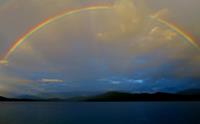 A rainbow over Rara Lake seen while trekking the Great Himalaya Trail
